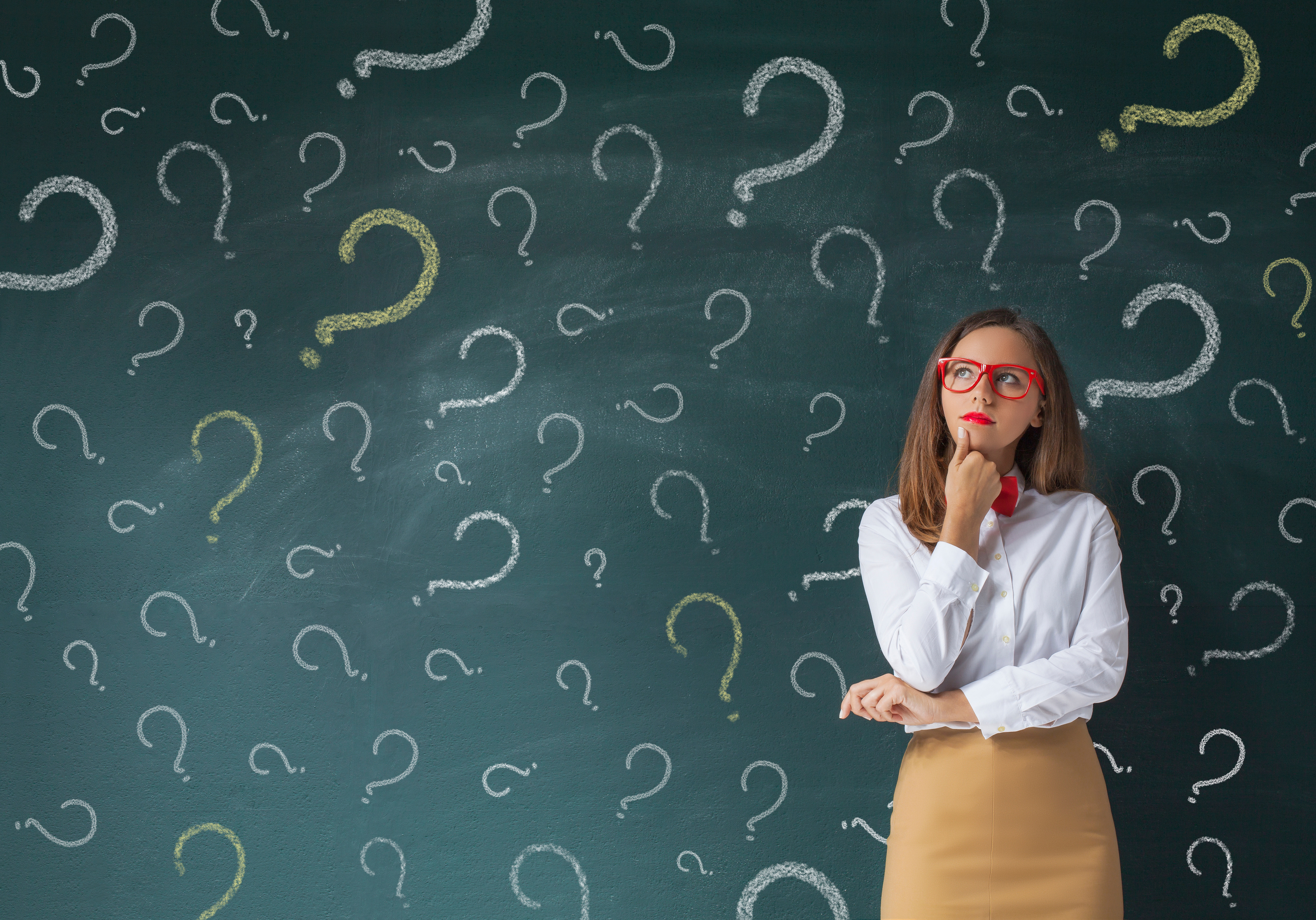 Wall of Question Marks Behind a Woman 